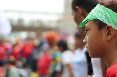 A child of a worker looks on as workers line up to begin the march to Liwasang Bonifacio.